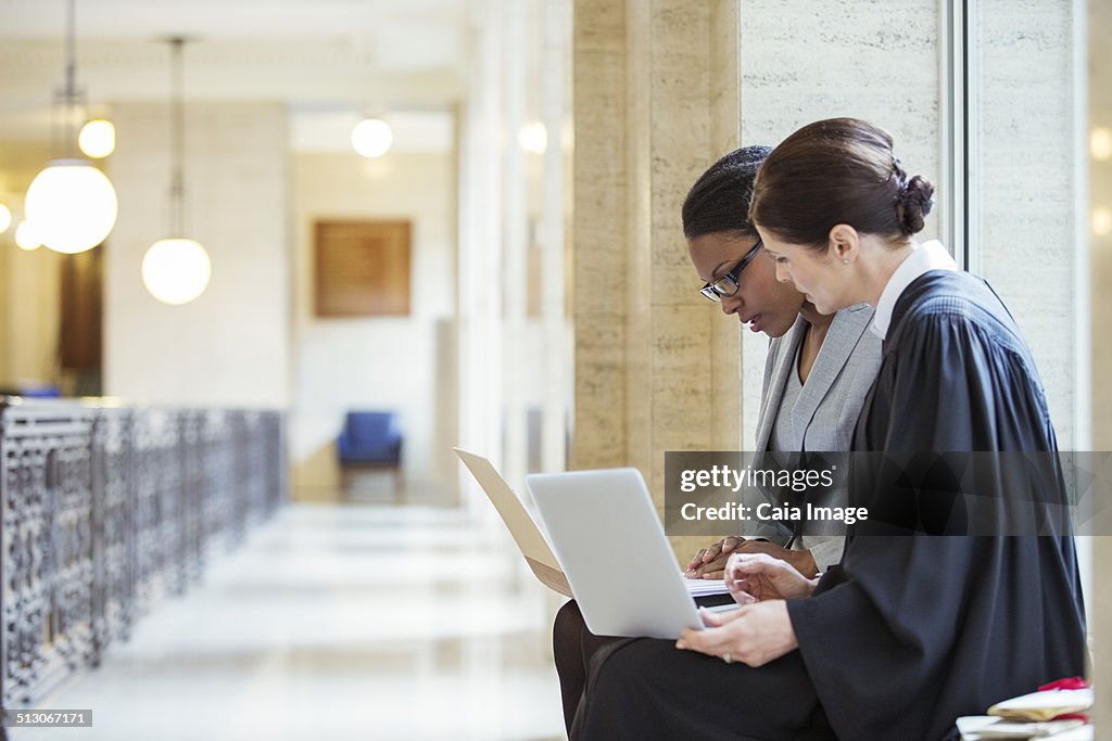 Judge and lawyer examining documents together