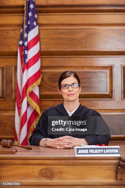 judge sitting at judges bench in court - judge robe stock pictures, royalty-free photos & images