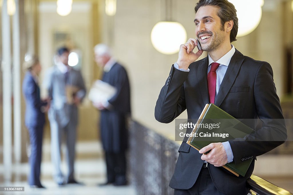 Lawyer talking on cell phone in courthouse