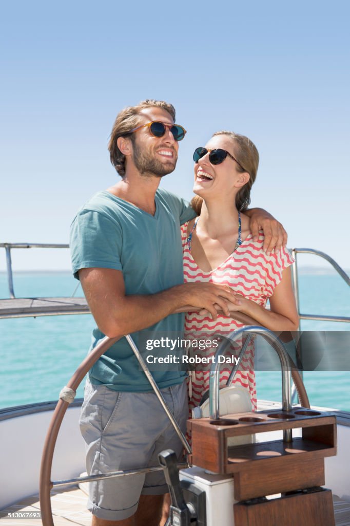 Couple steering boat together