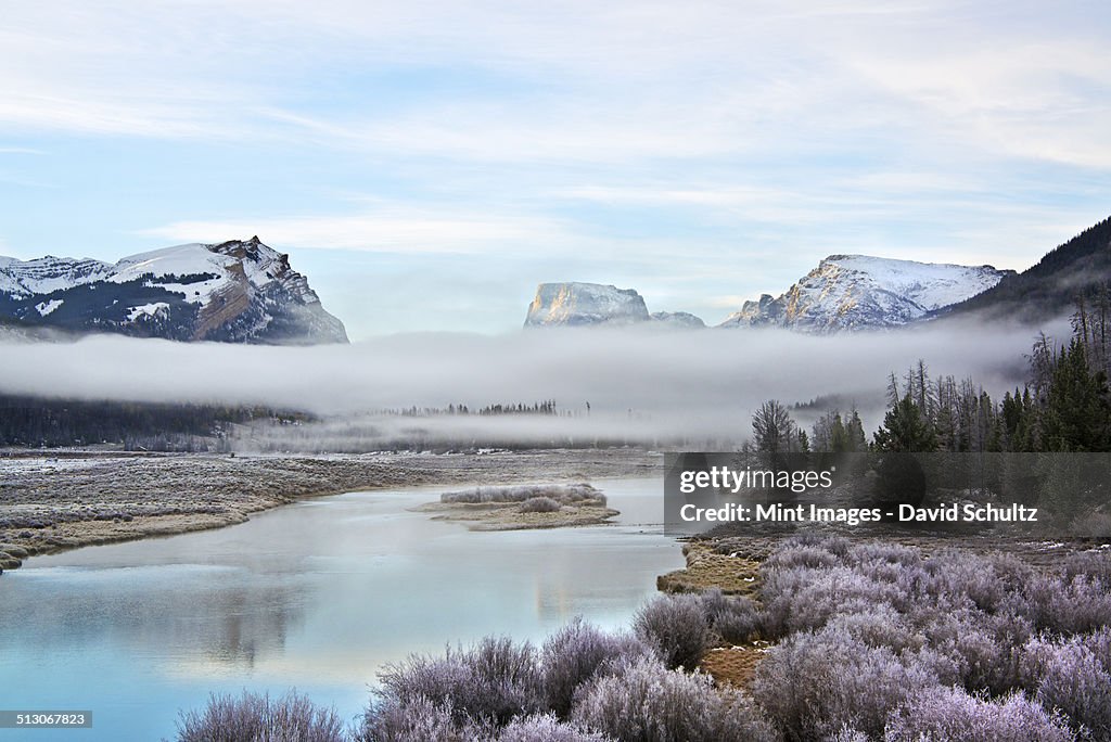 View of Squaretop Mountain, and the Wind River, at dawn, with low hanging mist over the valley.