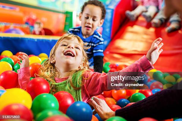 cheerful little girl in playroom. - ball pit stock pictures, royalty-free photos & images