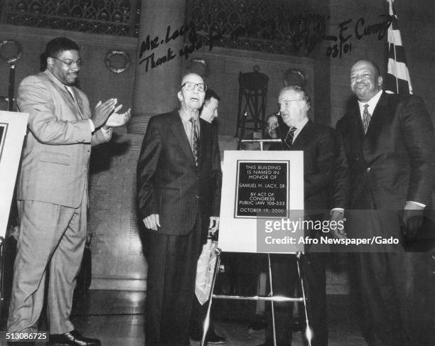 Former Afro American Newspapers sports reporter Sam Lacy and politician and Maryland congressional representative Elijah Cummings during a building...