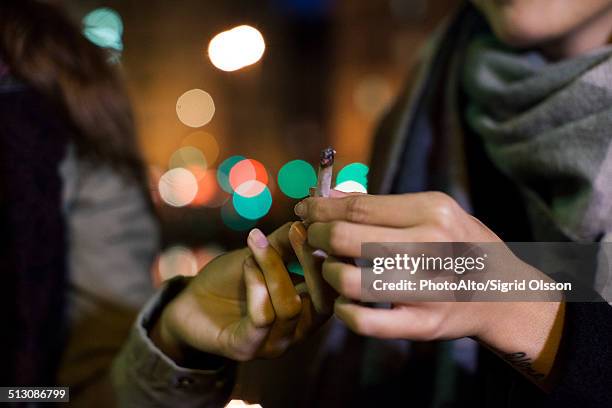 friends passing joint - smoking joint stock pictures, royalty-free photos & images