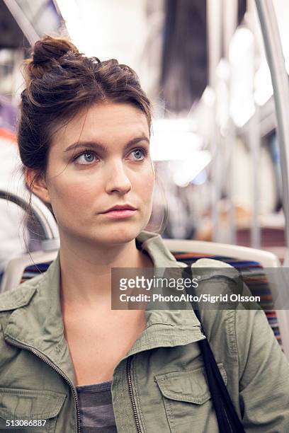 young woman riding subway train - femme metro photos et images de collection