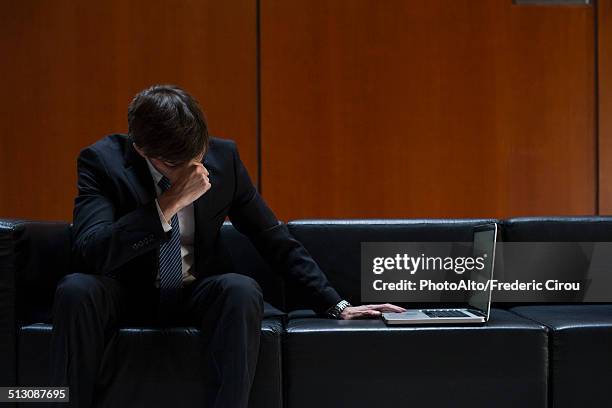 businessman covering eyes with hand in disbelief - stock market crash stock pictures, royalty-free photos & images