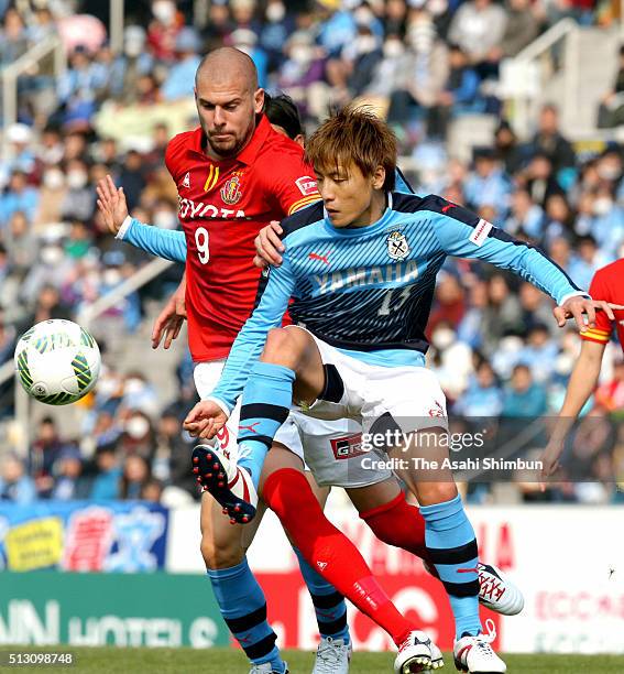 Robin Simovic of Nagoya Grampus and Tomohiko Miyazaki of Jubilo Iwata compete for the ball during the J.League match between Jubilo Iwata and Nagoya...