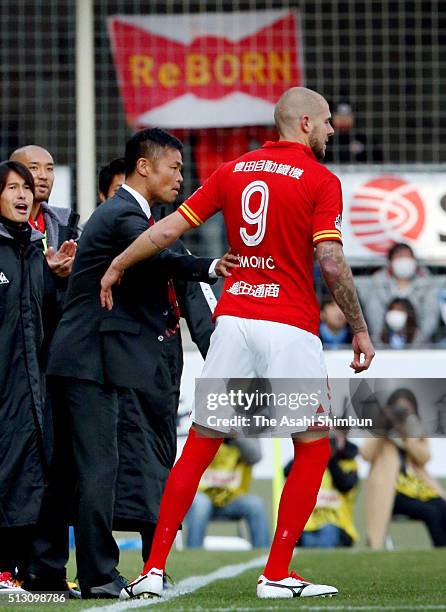 Nagoya Grampus head coach Takafumi Ogura instructs Robin Simovic during the J.League match between Jubilo Iwata and Nagoya Grampus at the Yamaha...