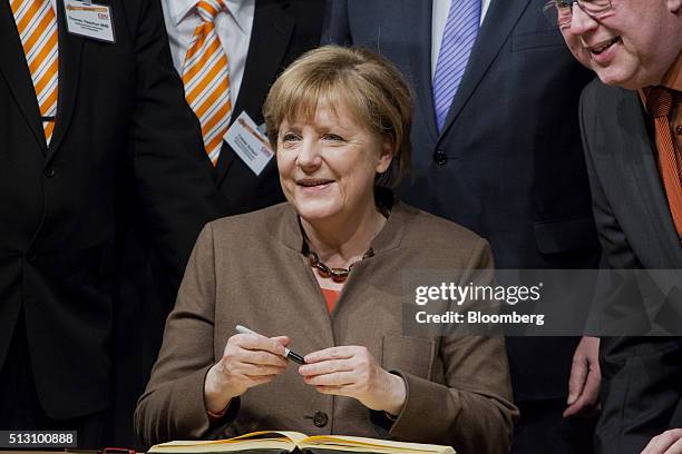 Angela Merkel, Germany's chancellor, smiles for a photograph before addressing a Christian Democratic Party local election campaign rally in...