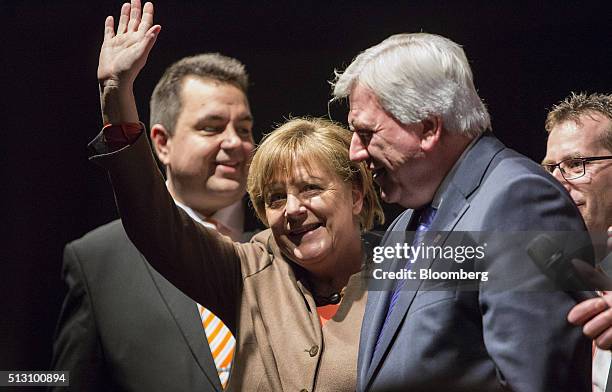 Angela Merkel, Germany's chancellor, waves to attendees before addressing a Christian Democratic Party local election campaign rally in Volkmarsen,...