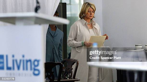 Martha Stewart prepares before making a statement to the media that she has decided to surrender for prison as soon as possible, citing the need to...