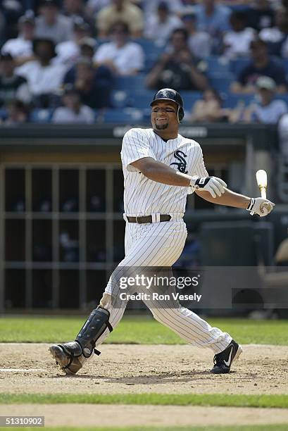 Outfielder Carlos Lee of the Chicago White Sox swings at a Cleveland Indians pitch during the game at U.S. Cellular Field on August 8, 2004 in...