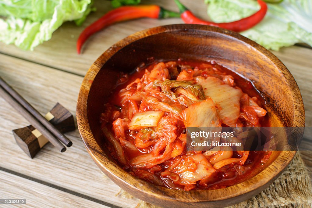 Kimchi with Chopsticks on wooden table, korean traditional food