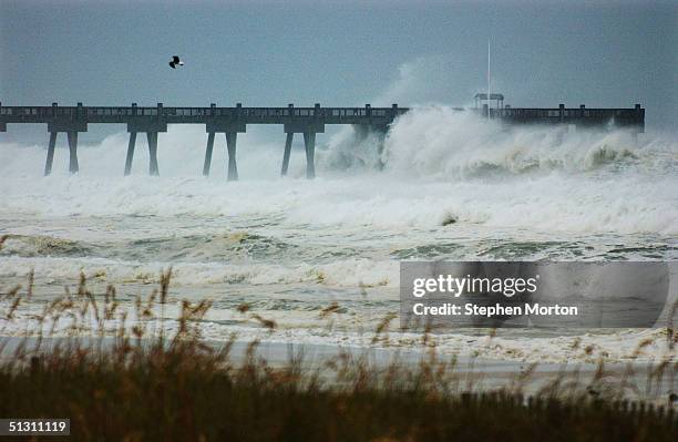 Pier takes a pounding as the outer bands of Hurricane Ivan lash the Florida panhandle September 15, 2004 in Pensacola Beach, Florida. Pensacola Beach...