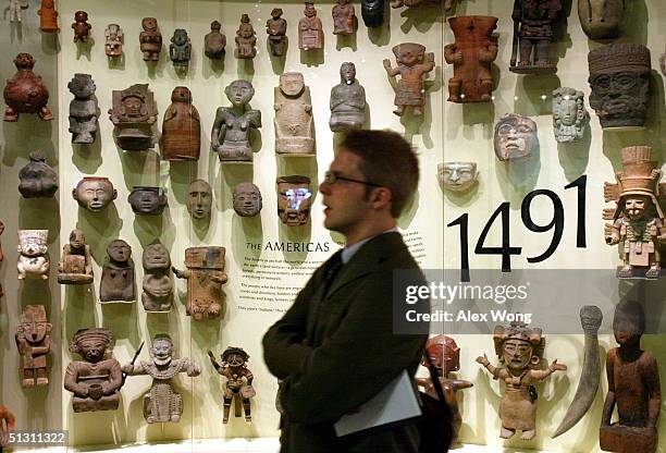 Alan Bjerga of the Knight Ridder Newspaper views a display of ceramic and stone figurines during a press preview September 15, 2004 at the...