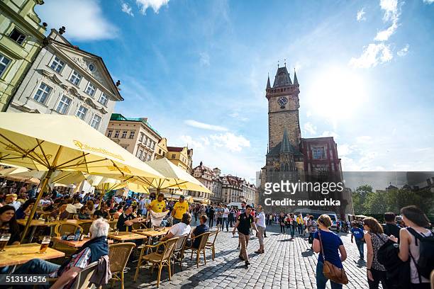 crowds of tourists on prague old town square - prague cafe stock pictures, royalty-free photos & images