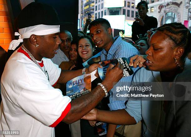 Singer Nelly signs autographs as part of the Z100 Pimp My Summer Contest at Times Square Studios September 15, 2004 in New York City. Nelly gave a...