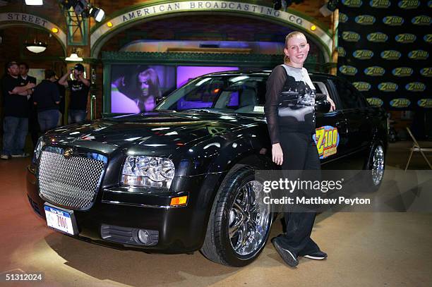 Contest Winner Melissa Kennedy of Mahopac, New York, poses with her new Chrysler 300 sedan as part of the Z100 Pimp My Summer Contest at Times Square...