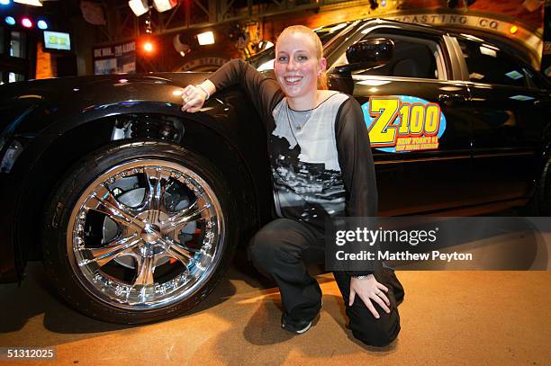 Contest Winner Melissa Kennedy of Mahopac, New York, poses with her new Chrysler 300 sedan as part of the Z100 Pimp My Summer Contest at Times Square...