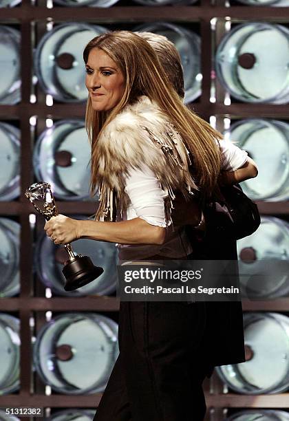 Canadian pop diva Celine Dion receives the Diamond Award, a special honor for being the top-selling female artist of all time, from actor Michael...