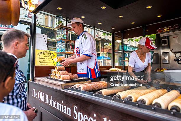 people buying famous trdelnik in prague - trdelník stock pictures, royalty-free photos & images