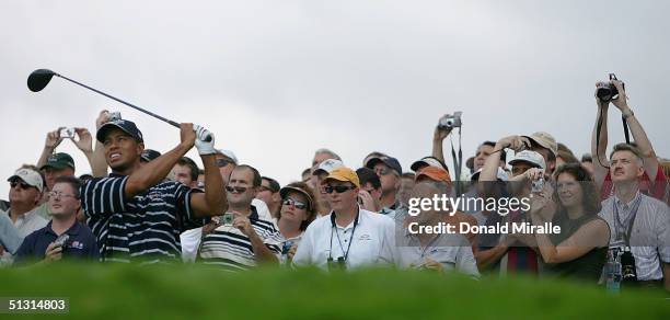 Team player Tiger Woods is the focus of attention as he drives off the 12th tee during the final practice day for the 35th Ryder Cup Matches at the...