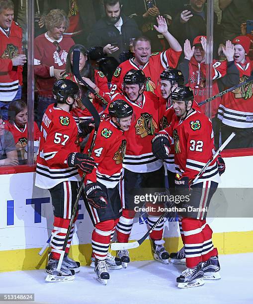 Trevor van Riemsdyk, Richard Panik, Dennis Rasmussen, Brandon Mashinter and Michal Rozsival of the Chicago Blackhawks celebrate Rasmussen's third...