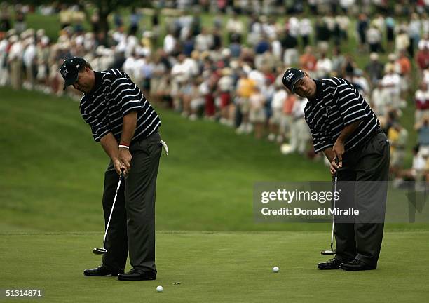 Team players Kenny Perry and Chris DiMarco practice their putting during the final practice day for the 35th Ryder Cup Matches at the Oakland Hills...