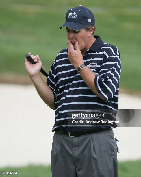 Team player Phil Mickelson waits on the practice green during the final practice day for the 35th Ryder Cup Matches at the Oakland Hills Country Club...