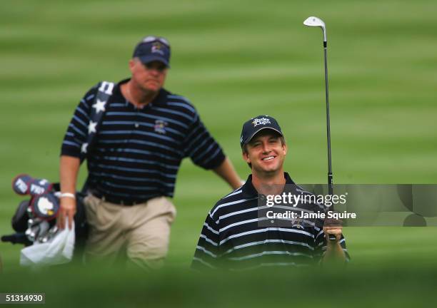 Team player David Toms walks with his caddie during the final practice day for the 35th Ryder Cup Matches at the Oakland Hills Country Club on...