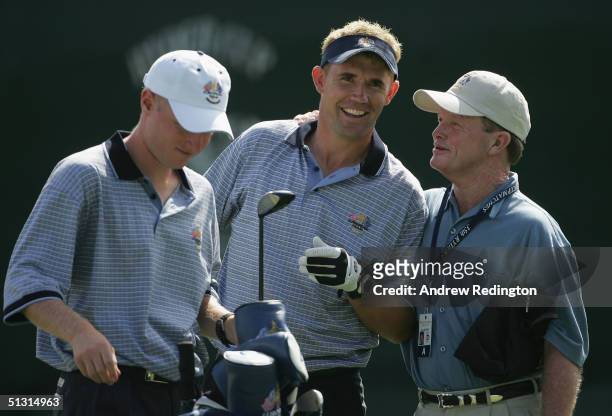 European team player Padraig Harrington of Ireland chats with his caddie and Tom Kite of the USA during the final practice day for the 35th Ryder Cup...
