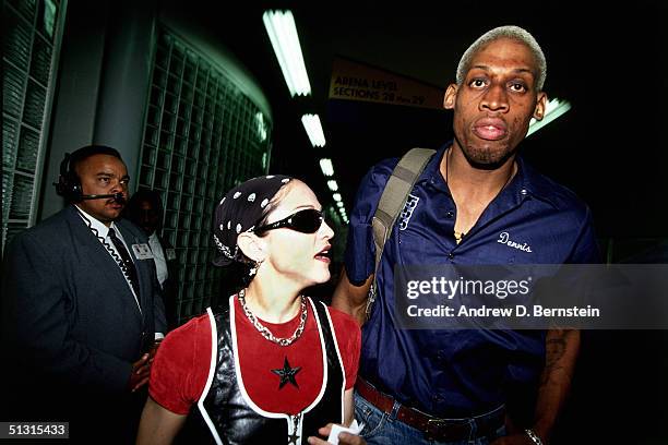 Dennis Rodman of the San Antonio Spurs is seen leaving the arena with Madonna after playing an NBA game against the Los Angeles Clippers at The Los...