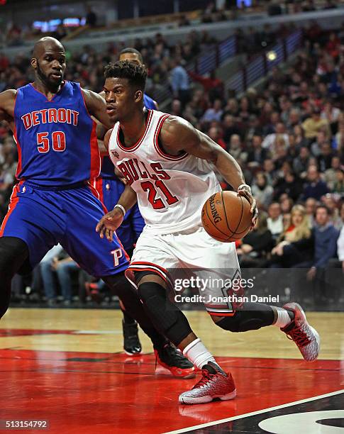 Jimmy Butler of the Chicago Bulls drives past Joel Anthony of the Detroit Pistons at the United Center on December 18, 2015 in Chicago, Illinois. The...