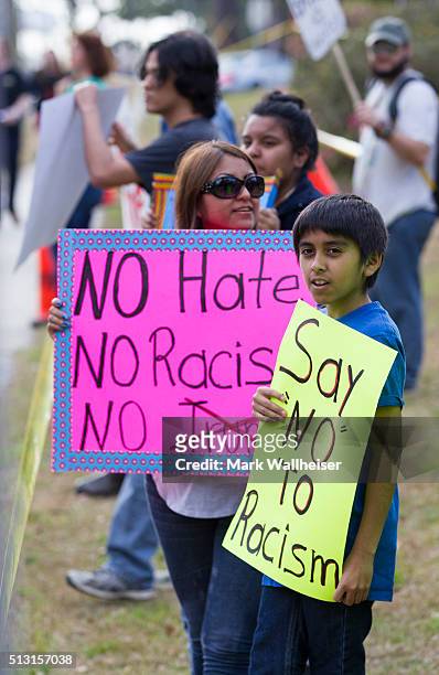 Eleven year-old Gilbert Garay Jr., of Valdosta, Georgia joins his family in protesting at a rally for Republican presidential candidate Donald Trump...