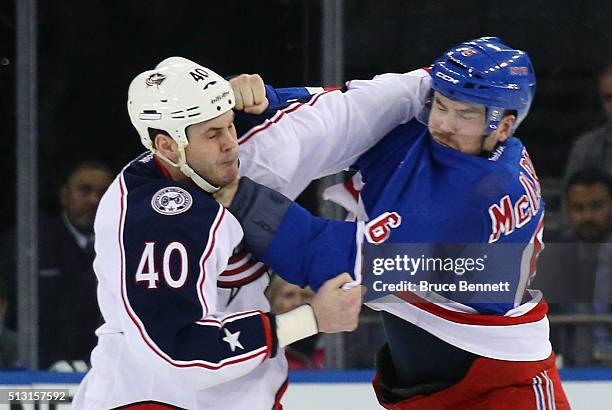 Jared Boll of the Columbus Blue Jackets and Dylan McIlrath of the New York Rangers fight during the second period at Madison Square Garden on...