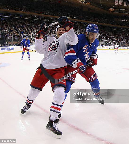 Dan Boyle of the New York Rangers and David Clarkson of the Columbus Blue Jackets pursue the puck during the first period on February 29, 2016 in New...