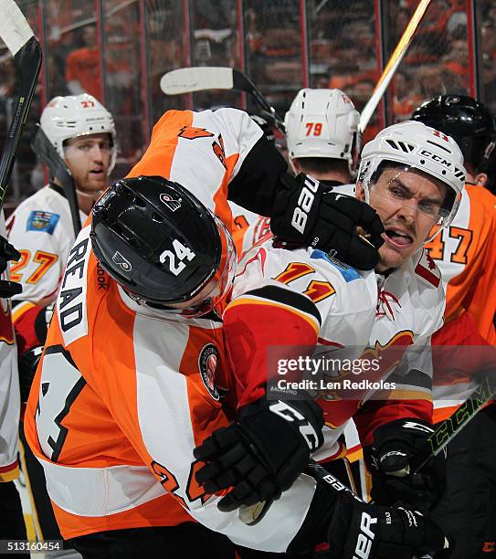 Matt Read of the Philadelphia Flyers scrums with Mikael Backlund of the Calgary Flames on February 29, 2016 at the Wells Fargo Center in...