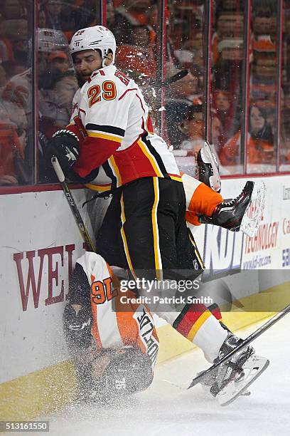 Chris VandeVelde of the Philadelphia Flyers is checked by Deryk Engelland of the Calgary Flames during the second period at Wells Fargo Center on...