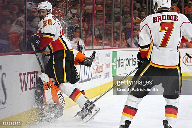 Chris VandeVelde of the Philadelphia Flyers is checked by Deryk Engelland of the Calgary Flames during the second period at Wells Fargo Center on...