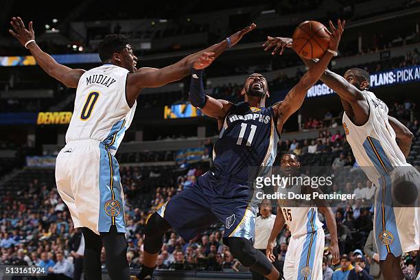 Mike Conley of the Memphis Grizzlies goes up for a shot and is fouled by Emmanuel Mudiay of the Denver Nuggets at Pepsi Center on February 29, 2016...