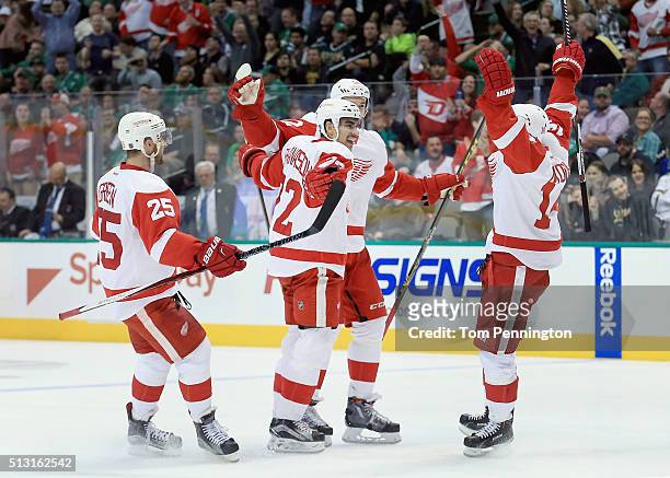Andreas Athanasiou of the Detroit Red Wings celebrates with Mike Green of the Detroit Red Wings, Jonathan Ericsson of the Detroit Red Wings and...