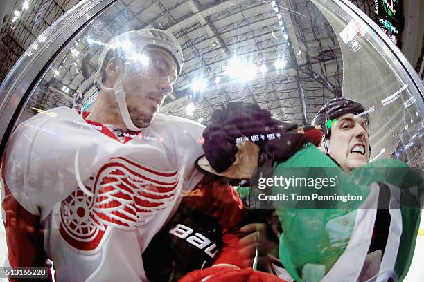 Jonathan Ericsson of the Detroit Red Wings checks Jamie Benn of the Dallas Stars into the glass in the second period at American Airlines Center on...