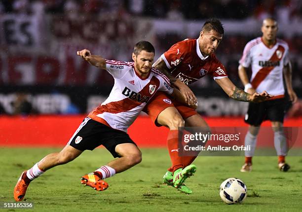 Joaquin Arzura, of River Plate, and German Denis, of Independiente, fight for the ball during a match between River Plate and Independiente as part...