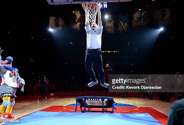 Steve Ballmer, owner Los Angeles Clippers, dunks a basketball after introducing the team mascot, a California Condor named "Chuck," during the...