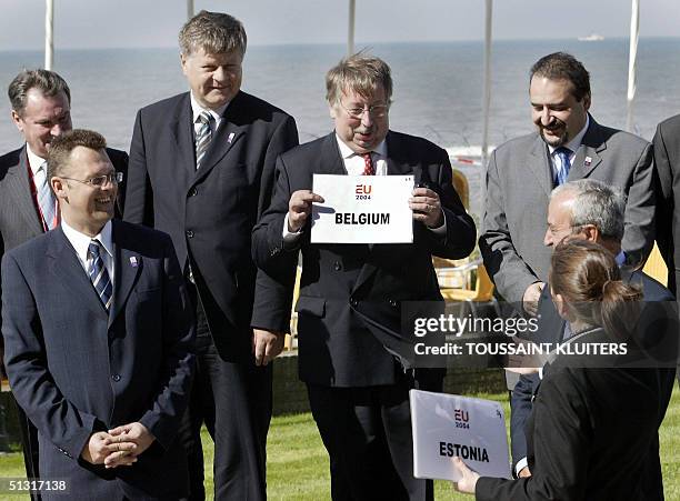 Belgian Defence Minister Andre Flahaut poses with a sign with the name of his country during the group photo after a meeting of EU defence ministers...