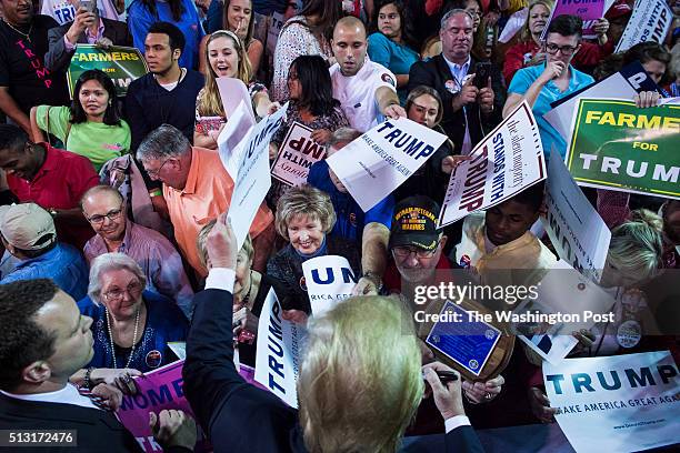 Supporters reach for signatures, handshakes, and photos as republican presidential candidate Donald Trump greets the crowd after speaking at a...