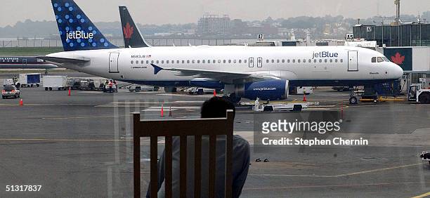 JetBlue Airways jet rests at it's gate awaiting passengers at LaGuardia Airport September 17, 2004 in New York City. JetBlue Airways, New York's...