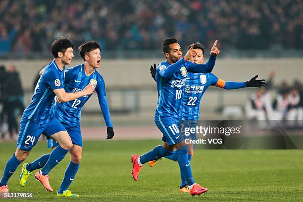 Alex Teixeira of Jiangsu Suning celebrates with team mates after scoring his team's first goal during the AFC Champions League Group E match between...