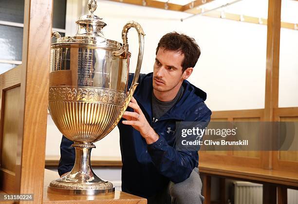 Andy Murray looks at the Aegon Championships trophy at The Queens Club Dressing Rooms on February 26, 2016 in London,United Kingdom. He will try to...