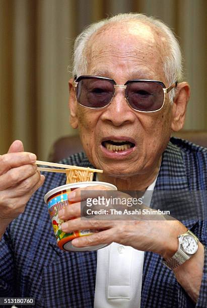 Nissin Foods founder and chairman Momofuku Ando eats the 'Chicken Ramen' during the Asahi Shimbun interview at the company headquarters on August 25,...